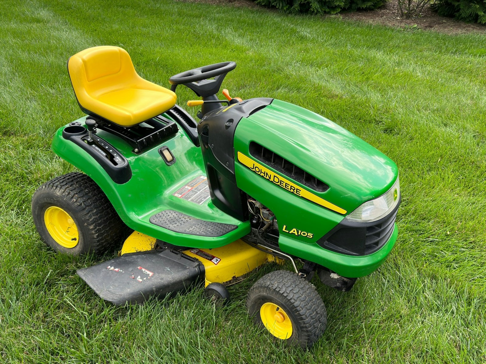 Lawn mower on a lush green field